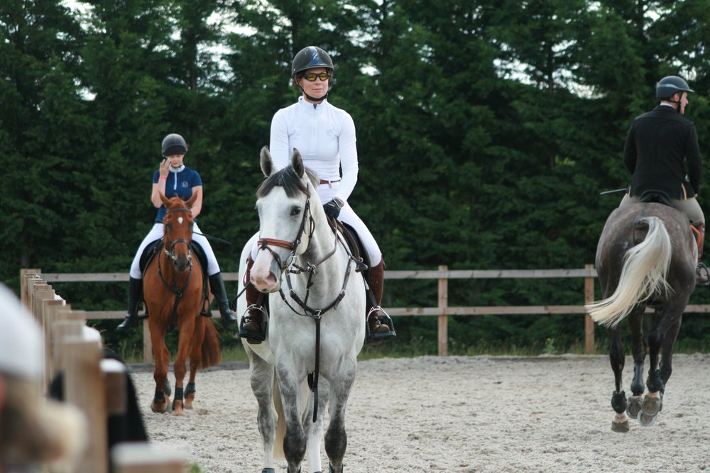 Nikki Ward on a dapple grey in the collecting ring